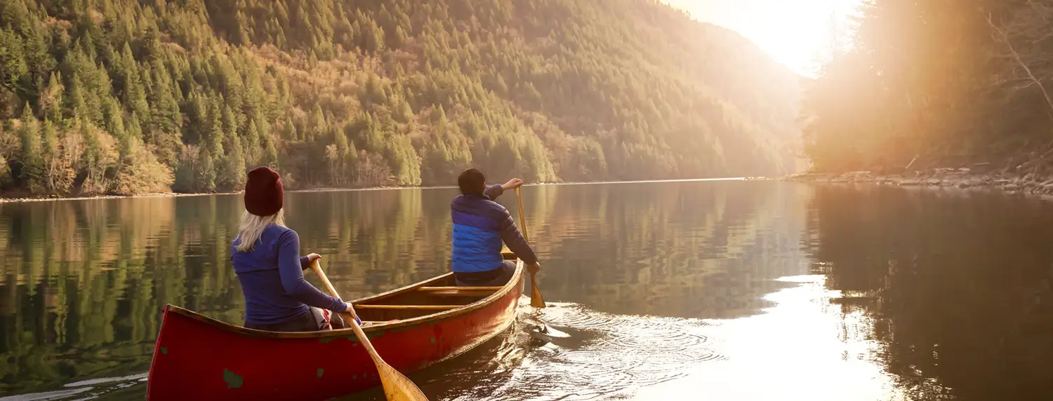 Canoe going down a clear river